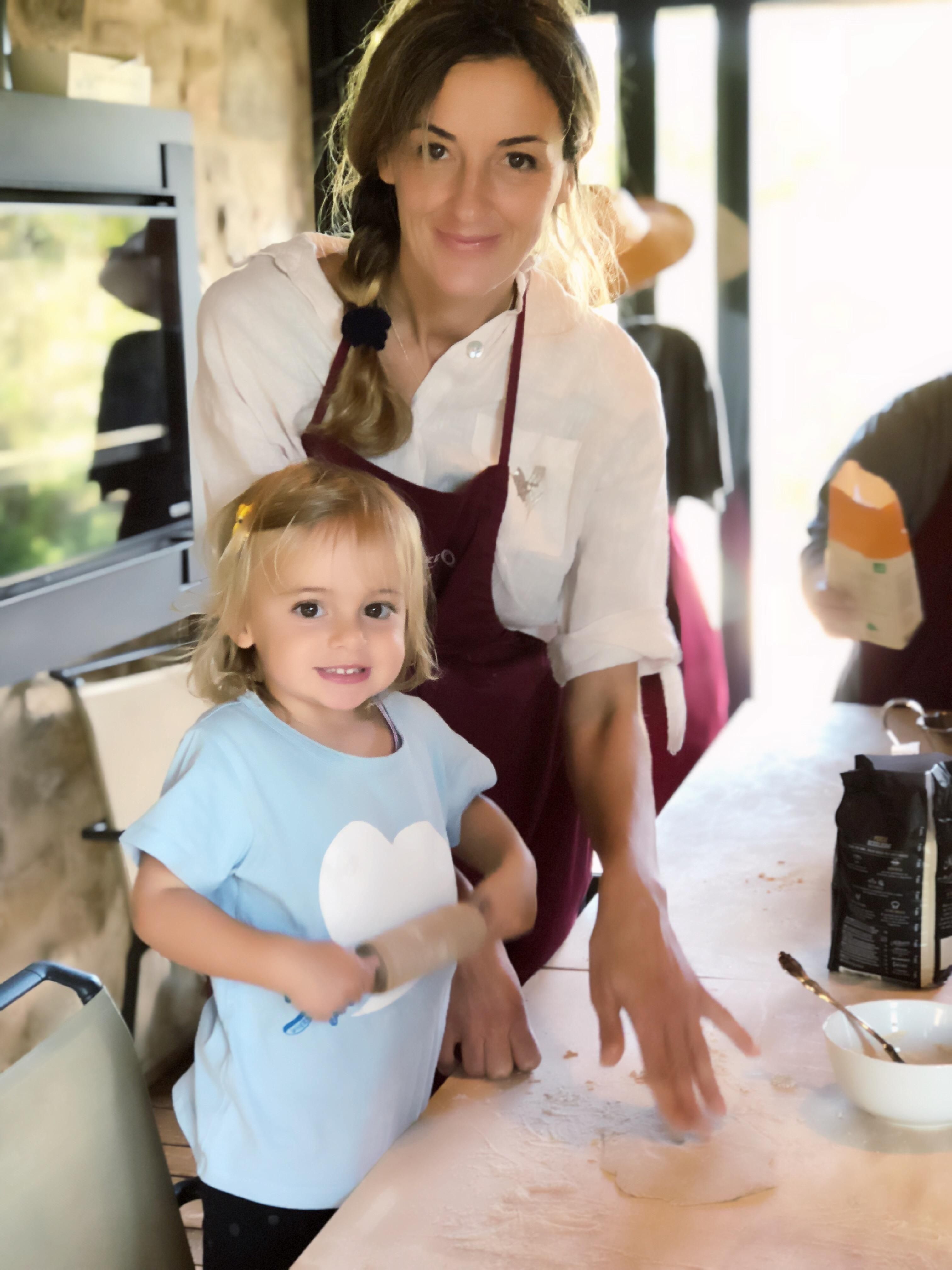 Owner Alina Pinelli and her daughter Stella cooking pasta during a cooking a class