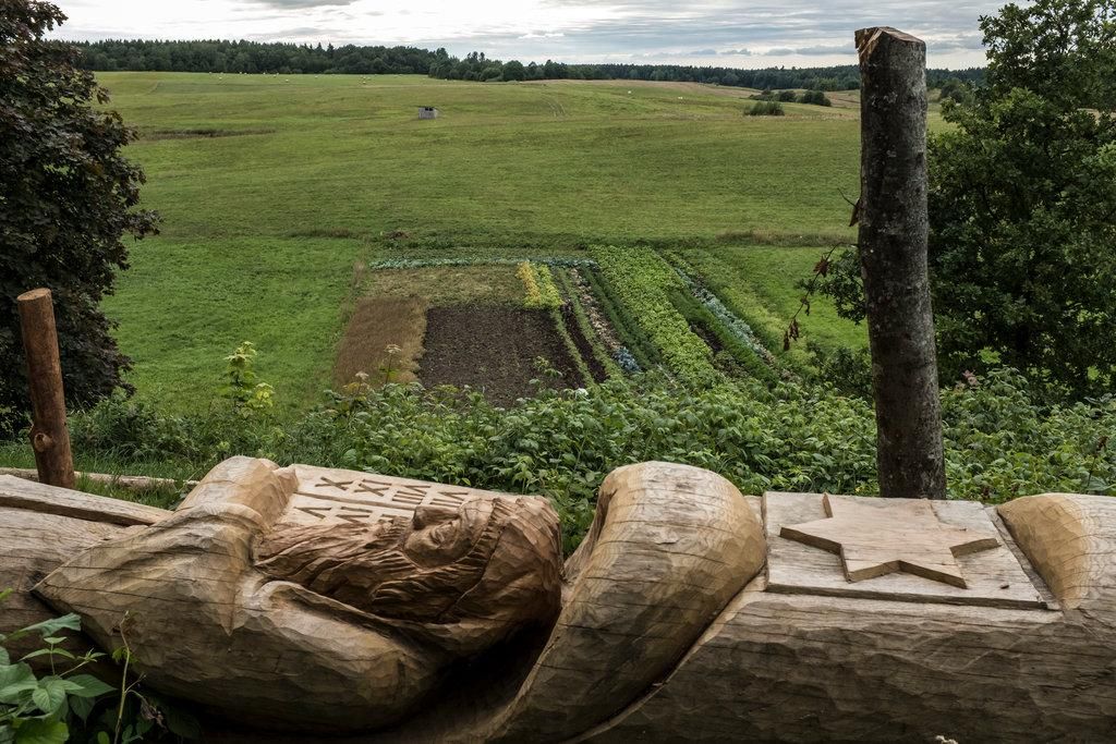 A carved log depicting Moses with the Ten Commandments on a hill in Plateliai, Lithuania, that was the site of the mass murder of Jewish men during World War II.CreditBrendan Hoffman for The New York Times