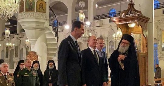 © REUTERS / SANA Президент России Владимир Путин и президент Сирийской Арабской Республики Башар Асад в Соборе Святой Девы Марии в Дамаске, Сирия. 7 января 2020