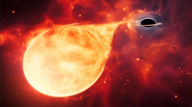 ESA/HUBBLE, M. KORNMESSER Image caption Черная дыра "засветилась", когда стала пожирать оказавшуюся рядом звезду (рисунок художника)