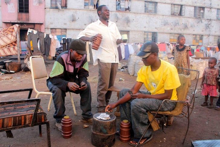 Мужчины играют в карты на улице в двухмиллионном Хараре — столице Зимбабве, ставшего самой несчастной страной мира. ФотоMajority World CIC / Alamy